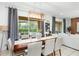 Bright dining area with table, chairs, and view of the backyard pool at 5229 Oakbourne Ave, Davenport, FL 33837