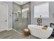 Spa-like bathroom with a soaking tub, walk-in shower, and modern fixtures at 10472 Petrillo Way, Winter Garden, FL 34787