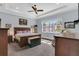 Bright main bedroom with carpeted floors, a king-size bed, and a large window at 10472 Petrillo Way, Winter Garden, FL 34787