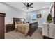 Bedroom with a king-size bed, dark wood furniture, and neutral decor at 10472 Petrillo Way, Winter Garden, FL 34787