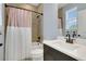 Bathroom with tub shower, single sink vanity, and modern fixtures at 10472 Petrillo Way, Winter Garden, FL 34787