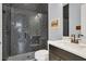 Bathroom with dark-tile shower, floating vanity, and modern fixtures at 10472 Petrillo Way, Winter Garden, FL 34787