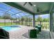 Relaxing screened-in pool and spa with patio furniture at 10472 Petrillo Way, Winter Garden, FL 34787