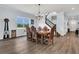 Elegant dining room with hardwood floors, a large table, and a view of the staircase at 10472 Petrillo Way, Winter Garden, FL 34787