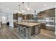 Modern kitchen with stainless steel appliances, granite countertops, and ample cabinet space at 10472 Petrillo Way, Winter Garden, FL 34787