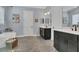Double vanity bathroom with modern dark brown cabinets and quartz countertops at 10472 Petrillo Way, Winter Garden, FL 34787