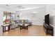 Spacious living room featuring a comfortable sectional sofa and large TV at 2654 Rosemont Cir, Davenport, FL 33837