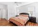 King bed in bright bedroom with wood floors and ceiling fan at 2654 Rosemont Cir, Davenport, FL 33837