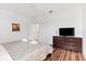 Large bedroom with king-size bed, flat-screen TV, and hardwood floors at 2654 Rosemont Cir, Davenport, FL 33837