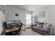 Home office with a desk, comfortable couch and large window at 2716 Fieldbrooke Way, Edgewater, FL 32141