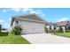 Charming house exterior with a two-car garage and well-manicured lawn at 2716 Fieldbrooke Way, Edgewater, FL 32141