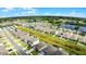 Aerial view of houses with solar panels and a green space at 2716 Fieldbrooke Way, Edgewater, FL 32141