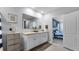 Double vanity bathroom with white cabinets and a large mirror at 2716 Fieldbrooke Way, Edgewater, FL 32141