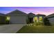 Two-story home with gray siding, white door, and landscaping at 2716 Fieldbrooke Way, Edgewater, FL 32141