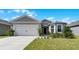 Charming house exterior with a two-car garage and landscaped yard at 2716 Fieldbrooke Way, Edgewater, FL 32141