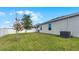 Spacious backyard with a grassy lawn, trees, and a white privacy fence at 2716 Fieldbrooke Way, Edgewater, FL 32141