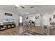 Open living and dining area with wood-look floors and access to kitchen at 2716 Fieldbrooke Way, Edgewater, FL 32141