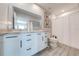 Modern bathroom with double vanity, tile flooring, and white cabinetry at 1475 Haines Dr, Winter Haven, FL 33881