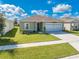 Single story house with a two car garage and well-manicured lawn at 1475 Haines Dr, Winter Haven, FL 33881