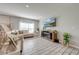 Bright living room featuring a fireplace and large TV at 1475 Haines Dr, Winter Haven, FL 33881