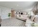 Spacious living room with L-shaped sofa and tile floors at 1475 Haines Dr, Winter Haven, FL 33881