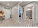 Bright hallway with tile flooring, leading to bedrooms and a bathroom at 1475 Haines Dr, Winter Haven, FL 33881
