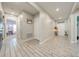 Bright hallway with tile flooring, leading to other rooms at 1475 Haines Dr, Winter Haven, FL 33881