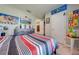 bedroom with Mario theme, striped bedding, and ample closet space at 1475 Haines Dr, Winter Haven, FL 33881