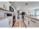 Modern kitchen with white cabinets, granite countertops, and stainless steel appliances at 1475 Haines Dr, Winter Haven, FL 33881