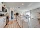 Modern kitchen with white cabinets, black appliances, and tile floor at 1475 Haines Dr, Winter Haven, FL 33881