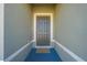 Front entry with gray door and a welcome mat at 1475 Haines Dr, Winter Haven, FL 33881