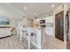 Modern kitchen with white cabinets and dark brown pantry door at 1475 Haines Dr, Winter Haven, FL 33881