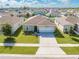 Aerial view of a single-story house with a solar panel system and a two-car garage at 1475 Haines Dr, Winter Haven, FL 33881