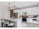 Modern kitchen with white cabinets, island, and stainless steel appliances at 2864 Sanctuary Dr, Clermont, FL 34714