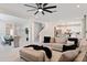 Spacious living room with light gray sectional sofa and large TV at 2864 Sanctuary Dr, Clermont, FL 34714