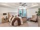 Relaxing main bedroom with sitting area and large windows at 2864 Sanctuary Dr, Clermont, FL 34714