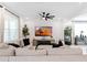 Spacious living room with large sectional sofa and a stunning sunset view at 2864 Sanctuary Dr, Clermont, FL 34714