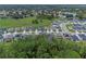 Aerial view of a residential neighborhood with houses near a golf course at 2864 Sanctuary Dr, Clermont, FL 34714