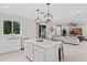 Open kitchen with island, white cabinets, and stainless steel appliances at 2864 Sanctuary Dr, Clermont, FL 34714
