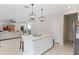 Open kitchen with island, white cabinets, and stainless steel appliances at 2864 Sanctuary Dr, Clermont, FL 34714