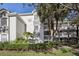 Exterior view of a condo building with lush landscaping and walkways at 13905 Fairway Island Dr # 1022, Orlando, FL 32837