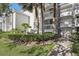 Condo building with a walkway, landscaping and palm trees at 13905 Fairway Island Dr # 1022, Orlando, FL 32837