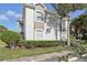 Exterior view of condo building with landscaping and parking at 13905 Fairway Island Dr # 1022, Orlando, FL 32837