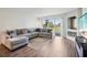 Spacious living room with L-shaped sectional sofa and wood-look flooring at 13905 Fairway Island Dr # 1022, Orlando, FL 32837