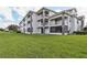 Three-story building with balconies and grassy lawn at 13905 Fairway Island Dr # 1022, Orlando, FL 32837