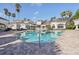 Inviting community pool with palm trees and a large sundeck at 13905 Fairway Island Dr # 1022, Orlando, FL 32837
