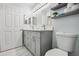 Updated bathroom with double vanity, gray cabinets, and marble floors at 13905 Fairway Island Dr # 1022, Orlando, FL 32837