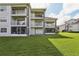 Three-story building with balconies and grassy lawn at 13905 Fairway Island Dr # 1022, Orlando, FL 32837