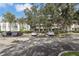 Condo building with parking lot and lush landscaping at 13905 Fairway Island Dr # 1022, Orlando, FL 32837