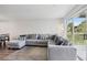 Living room with L-shaped sectional sofa and access to a balcony at 13905 Fairway Island Dr # 1022, Orlando, FL 32837